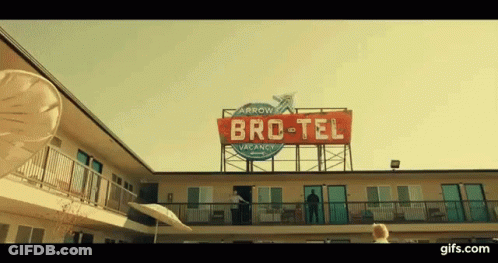 Man On Motel Balcony With Bro-Tel Vacancy Sign GIF