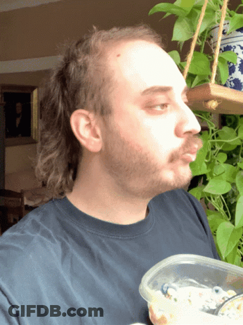 Man On Mullet Eating Snacks GIF