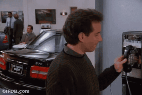 Man On Pay Phone Next To Car Saying Night GIF