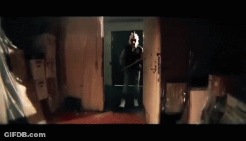Man On Phone Holding Baseball Bat In Dark Room GIF