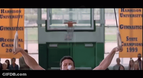 Man On Rings At Harrison University Gymnastics GIF