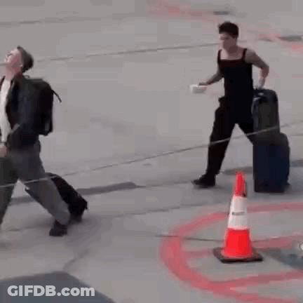 Man On Runway With Suitcase And Bowl GIF