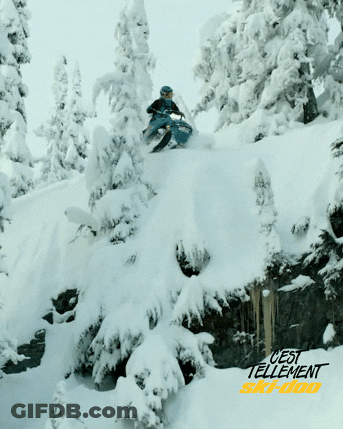 Man On Snowmobile Jumping Off A Snowy House GIF