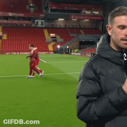 Man On Soccer Field In Front Of Expedia Sign GIF