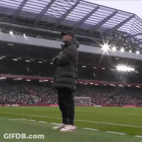 Man On Soccer Field In Front Of Stadium GIF