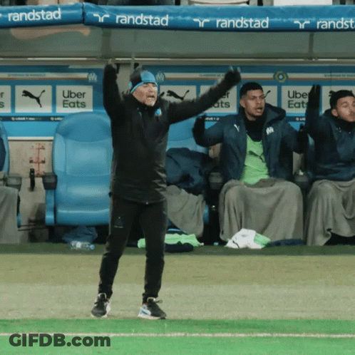 Man On Soccer Field With Arms In Air GIF