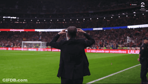 Man On Soccer Field With Arms Outstretched In Front Of LG Ad GIF