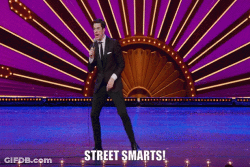 Man On Stage Holding Microphone With Street Smarts GIF