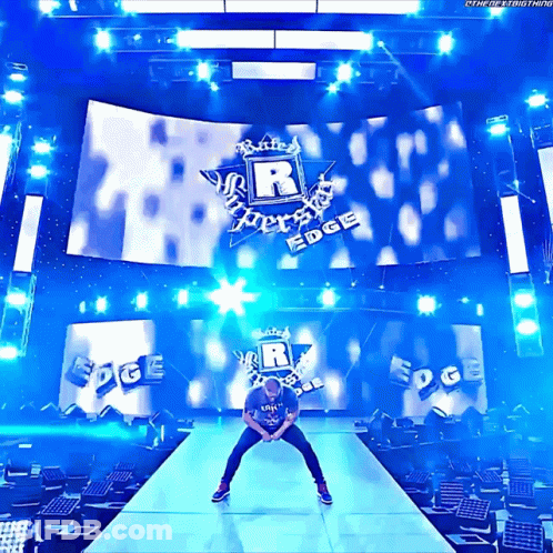 Man On Stage In Front Of Large R Logo GIF