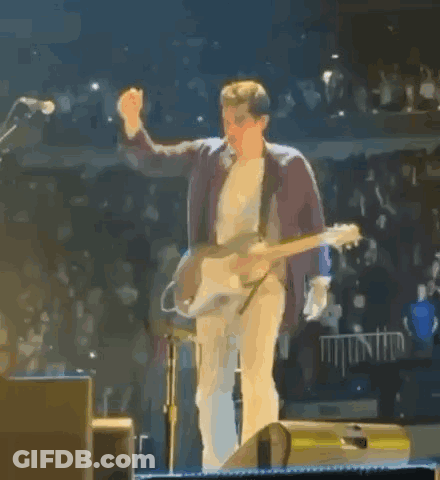 Man On Stage Playing Guitar Giving Middle Finger GIF