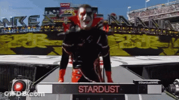 Man On Stage With Stardust Sign GIF