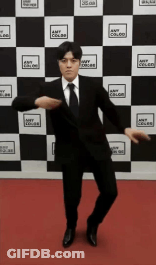 Man On Suit Dancing Against Checkered Wall GIF