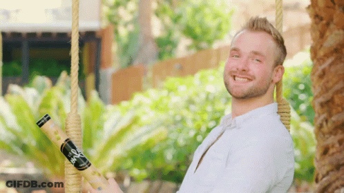 Man On Swing Holding Bio Bottle GIF