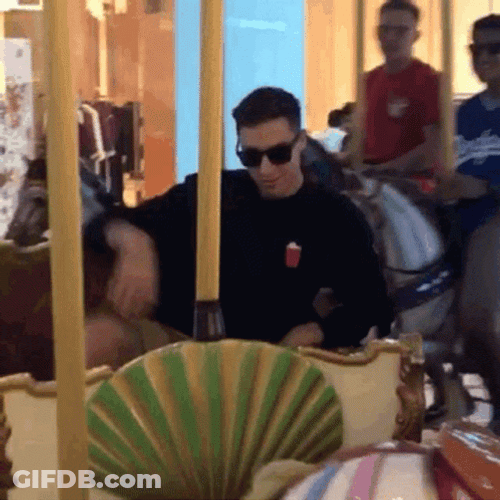 Man On The Carousel Blowing Kiss GIF