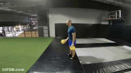 Man On Trampoline Holding Frisbee GIF