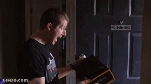 Man Opening Box In Front Of No Soliciting Sign GIF