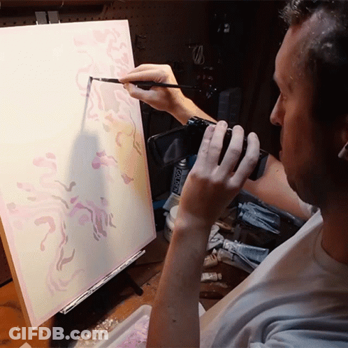 Man Painting On Canvas Holding Camera And Acrylic Paint GIF