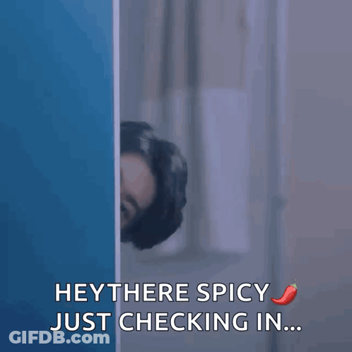 Man Peeking Behind Wall Saying Hey There Spicy GIF
