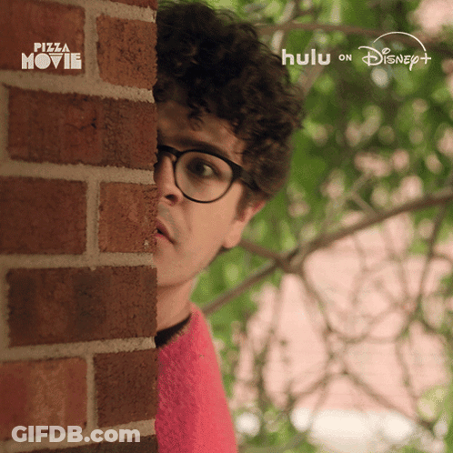 Man Peeking From Behind Brick Wall With Hulu On Disney Logo GIF