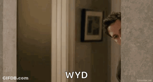 Man Peeking Out Doorway Saying WYD GIF