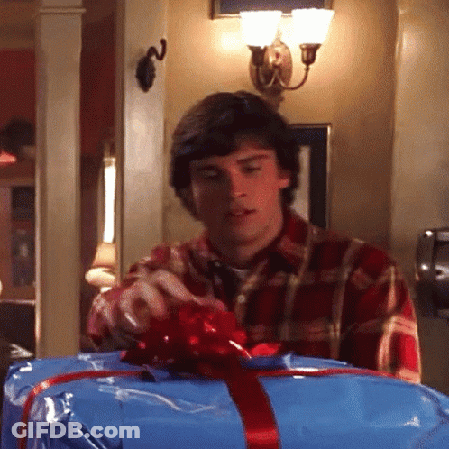 Man Plaid Shirt Puts Red Bow Blue Box GIF