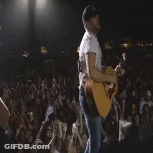 Man Playing Acoustic Guitar In Front Of Crowd GIF