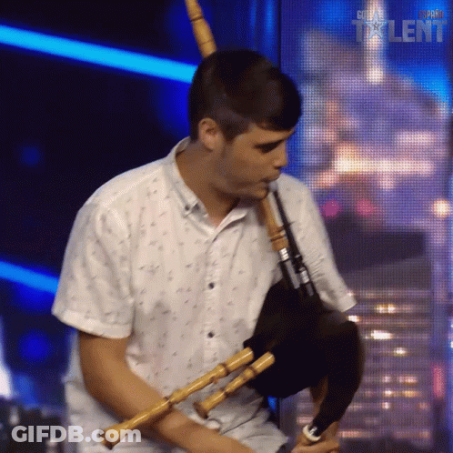 Man Playing Bagpipe In Front Of Super Talent Sign GIF