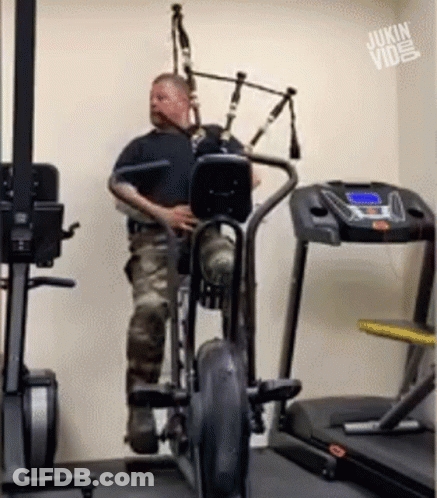 Man Playing Bagpipe On Exercise Bike GIF