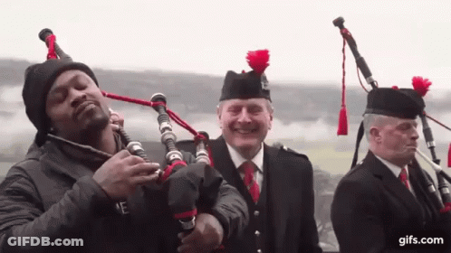 Man Playing Bagpipe With Kilted Men GIF