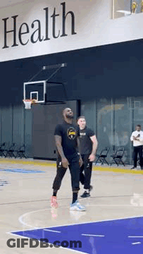 Man Playing Basketball In Front Of Health Sign GIF