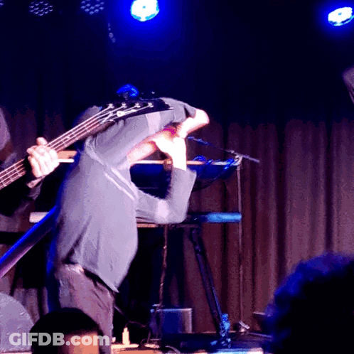 Man Playing Bass Guitar On Stage With Keyboard GIF