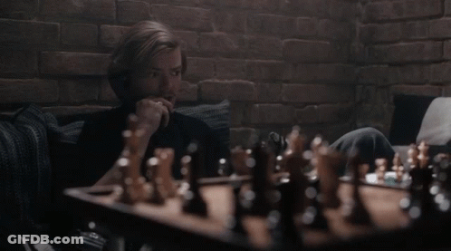 Man Playing Chess On Couch GIF