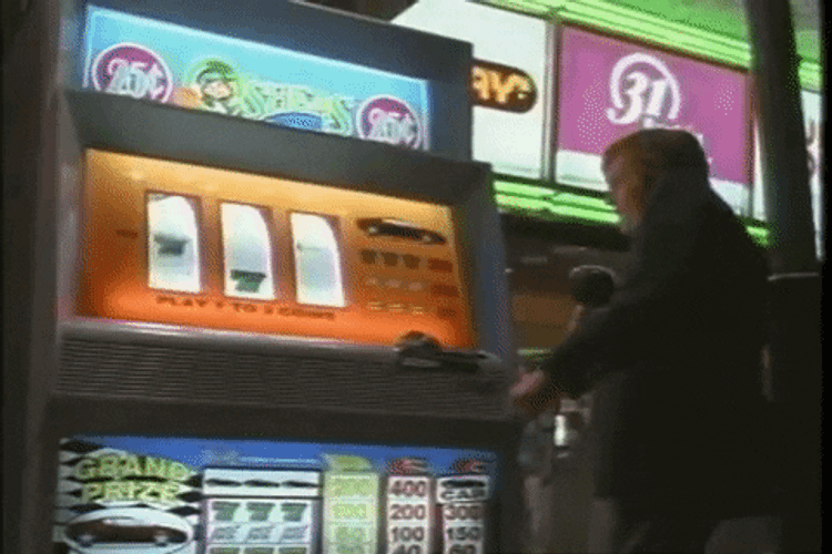 Man Playing Coin Slot In Vegas Vacation GIF