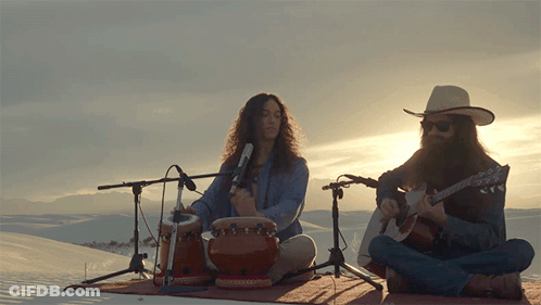 Man Playing Drum And Guitar In Front Of Microphones GIF