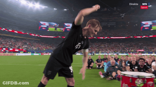 Man Playing Drum On NRK Soccer Field GIF