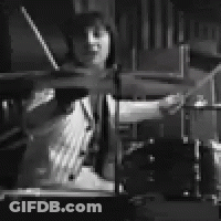 Man Playing Drum Set In Black And White GIF