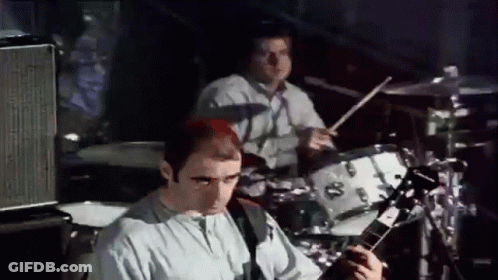 Man Playing Drums And Man Playing Guitar On Stage GIF