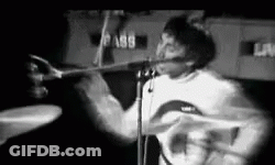 Man Playing Drums And Singing On Stage Black And White GIF