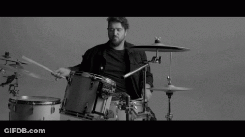 Man Playing Drums In Black And White GIF