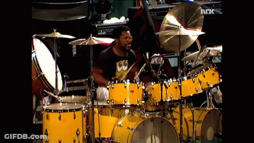 Man Playing Drums In Black Shirt Saying CC GIF