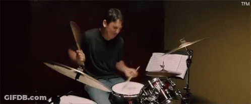 Man Playing Drums In Dark Room GIF