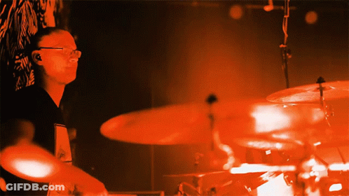 Man Playing Drums In Dark Room GIF