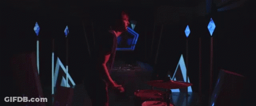 Man Playing Drums In Dark Room With Lights GIF