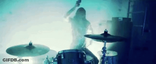 Man Playing Drums In Dark Room With Smoke GIF