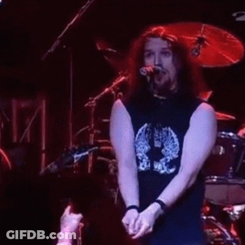 Man Playing Drums In Front Of Cheerleader GIF