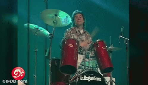 Man Playing Drums In Front Of La Baguetterie GIF