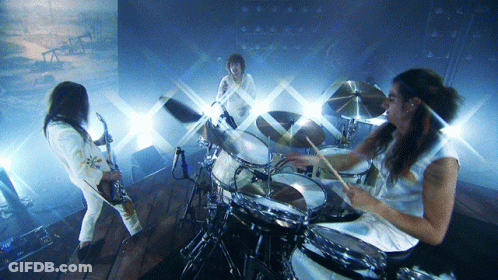 Man Playing Drums In Front Of Painting GIF