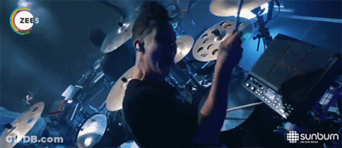 Man Playing Drums In Front Of Sunburn Advertisement GIF