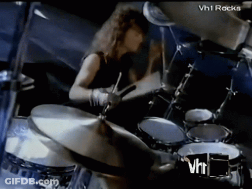 Man Playing Drums In Front Of VH1 Rocks Logo GIF