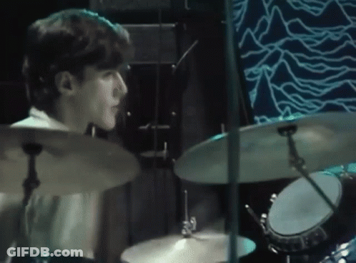 Man Playing Drums On Blue Stage GIF